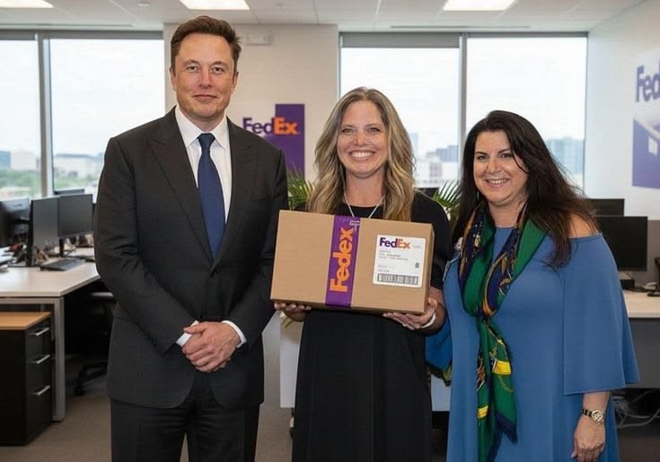 Three people posing together with a delivery package